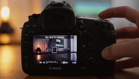 Canon DSLR camera displaying "No card in camera" error message on rear LCD screen.