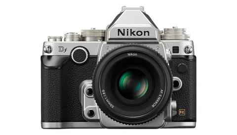 Nikon Df DSLR camera with silver top plate and black body, featuring a standard prime lens with green optical elements visible.