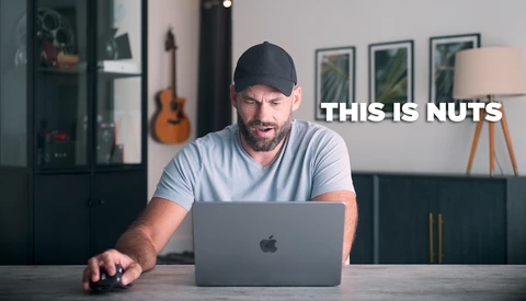 Man at desk with laptop reacting with an expression of disbelief while text overlay reads 'THIS IS NUTS'.