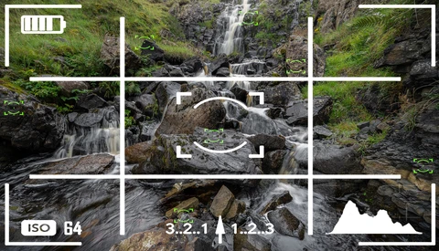 Camera viewfinder overlay displaying cascading waterfall with mossy rocks and long-exposure water effect.