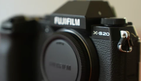Fujifilm X-S20 mirrorless camera body shown from front-left angle, highlighting the textured grip and control layout.