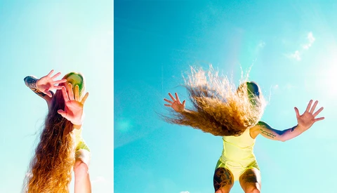 Two images of a person with long hair photographed against blue sky, one profile shot with arms raised, one action shot with hair in motion.