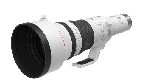 White telephoto lens with black interior barrel and focus ring against white background.