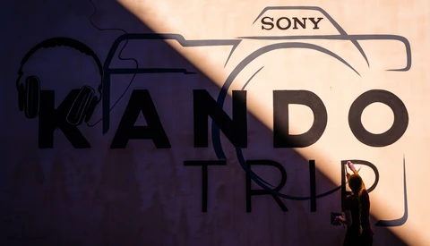 Graphic composition featuring Sony camera icon, headphones, microphone, and text overlay on warm and cool toned background.