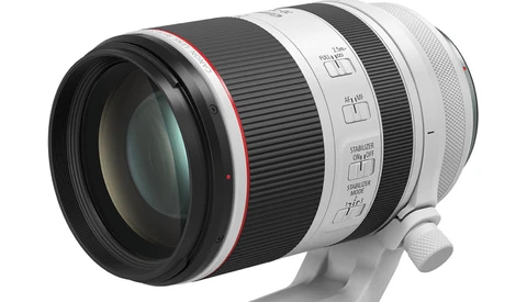 White and black telephoto lens with red accent ring and manual focus controls.