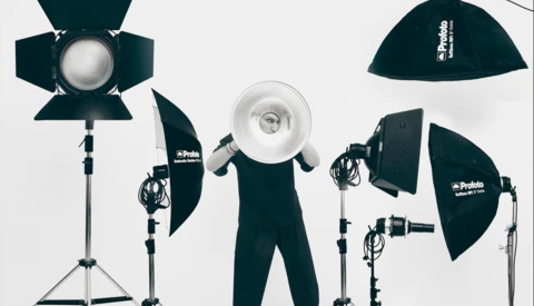 Professional studio lighting kit with five softboxes and reflectors arranged on stands against a white background.