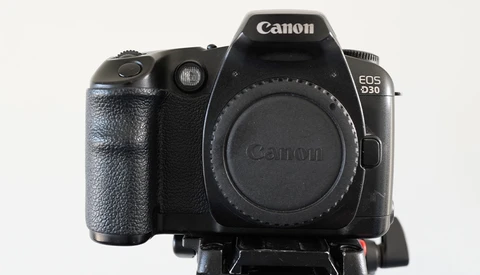 Canon EOS R30 mirrorless camera body front view showing grip and lens mount.