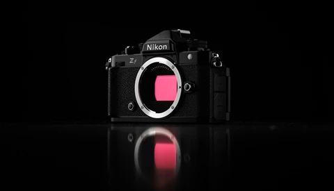 Nikon Z7 mirrorless camera body shown front-on against black background with mirror reflection below.