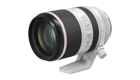 White and black telephoto lens with built-in tripod collar and focus ring controls.