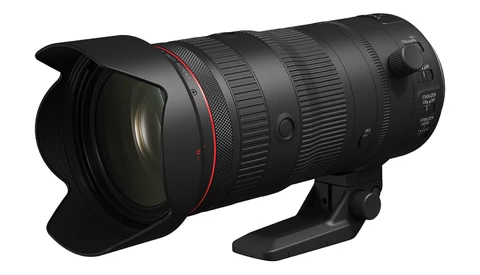Professional telephoto zoom lens with red accent ring and petal-type lens hood attached.
