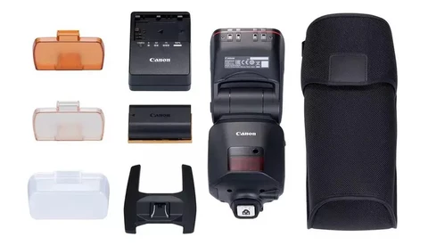 Canon Speedlite flash with accessories laid out flat, including battery chargers, diffuser, protective cases, and carrying pouch.