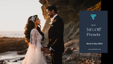 Bride and groom standing together under a natural stone arch during golden hour, with ocean visible in background.