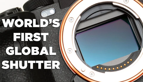 Close-up of a camera body with orange and white accent ring showing the mirror and sensor. Text reads 'World's First Global Shutter.'