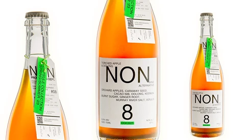 Three product photography angles of an orange NON 8 beverage bottle showing front label and side views.