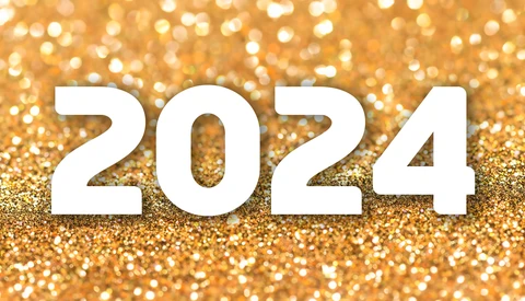 The number 2024 in white typography against a golden glitter background.
