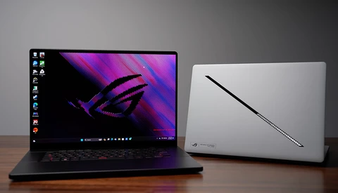 Two gaming laptops displayed on a wooden surface against a gray background.