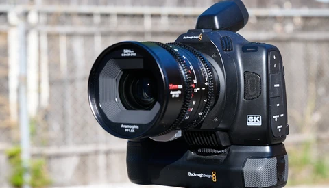 Blackmagic 6K cinema camera with anamorphic lens and shoulder rig mounted outdoors.