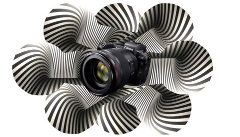 Canon DSLR camera surrounded by black and white striped spherical shapes against a white background.