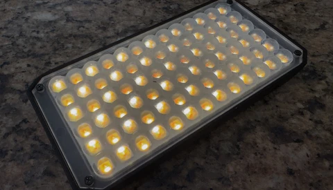 LED panel with approximately 80 warm-toned light sources arranged in a rectangular grid pattern.