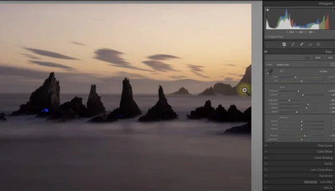 Screenshot of landscape photograph editing in Lightroom with rocky sea stacks silhouetted against twilight sky.