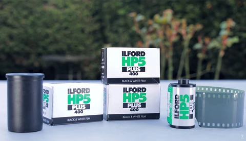 Ilford HP5 Plus 400 black and white film products displayed with canisters and boxes.
