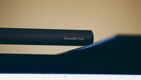 LG ScreenBar Halo monitor light with curved design mounted above display against neutral background.