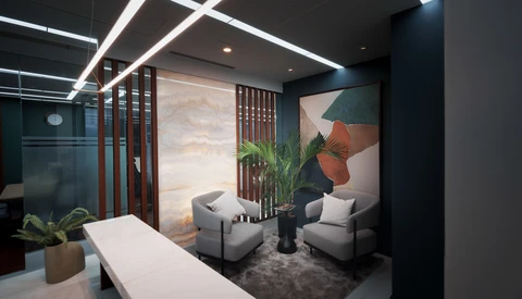 Modern interior design rendering of a lounge area with contemporary furniture and geometric wall art.