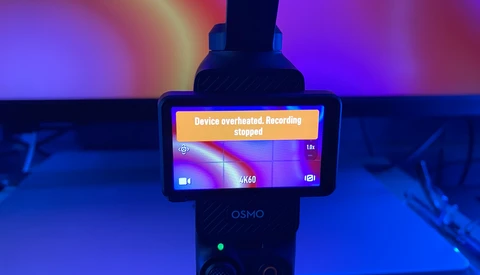 DJI Osmo handheld gimbal displaying overheated recording stopped error message on its screen.