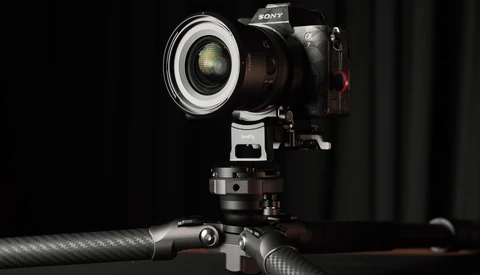 Sony mirrorless camera mounted on tripod with ring light modifier attached to lens.