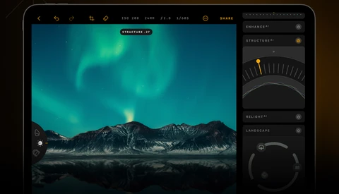 Screenshot of photo editing software showing aurora borealis over mountains with adjustment panels on right.