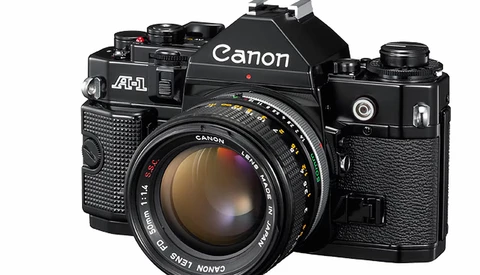 Canon A-1 35mm SLR camera with standard prime lens mounted, shown in three-quarter front view.