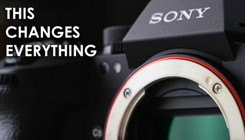Close-up of Sony camera body showing sensor and lens mount with red accent ring.