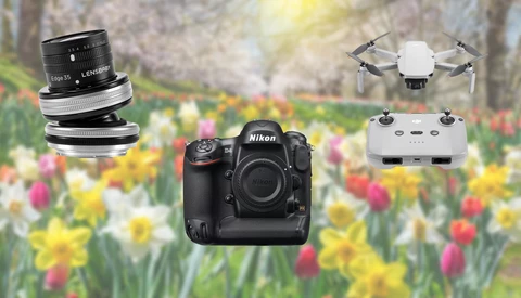 Nikon DSLR camera body with interchangeable lenses and a compact drone against a blurred floral background.