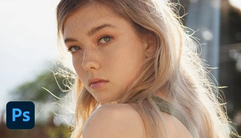Portrait of a young woman with blonde hair in golden hour sunlight, looking over her shoulder.