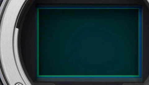 Camera viewfinder display with glowing teal frame border on dark background.