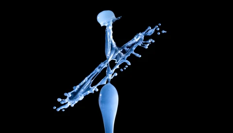 Blue water splash captured mid-air against a black background, with droplets suspended in dynamic motion.