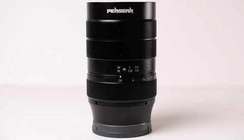 Pergear telephoto lens with focus ring and aperture markings displayed against neutral background.