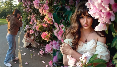Woman in off-shoulder white dress posing among blooming pink flowers during outdoor portrait session.