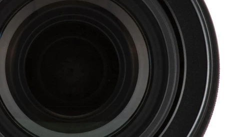 Close-up view of camera lens elements showing concentric glass rings and optical coatings.