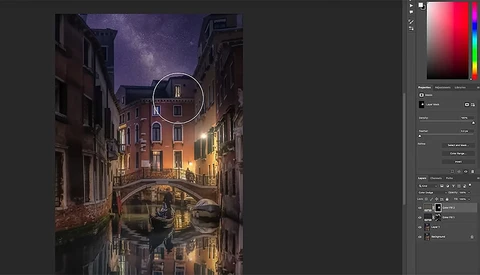 Venice canal at night with illuminated buildings, starry sky, and gondola reflection in still water.