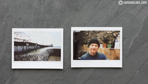 Two instant film photographs displayed side by side on a textured gray surface.