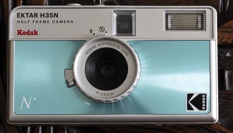 Kodak Ektar H35N half-frame camera with light blue body and chrome lens.