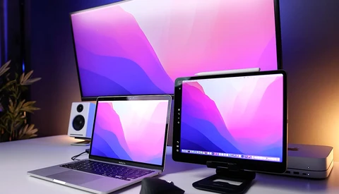 Multiple Apple devices displaying matching gradient wallpapers in pink and purple tones.