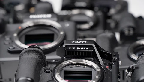 Panasonic Lumix camera body in sharp focus among several other camera bodies in soft focus background.