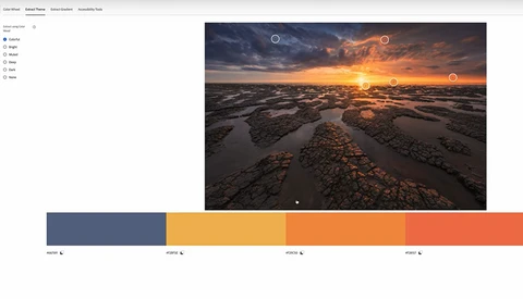 Dramatic coastal landscape at sunset with tidal flats, golden light reflecting on water, and warm-toned sky with storm clouds.