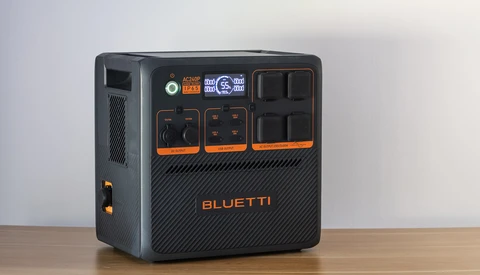 Bluetti portable power station with black casing and orange accents, featuring multiple AC outlets and control panels.