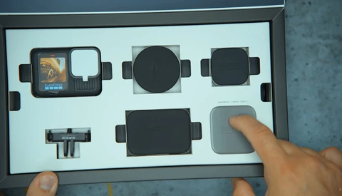 Overhead view of a camera accessory kit with protective cases and lens attachments displayed in custom foam.