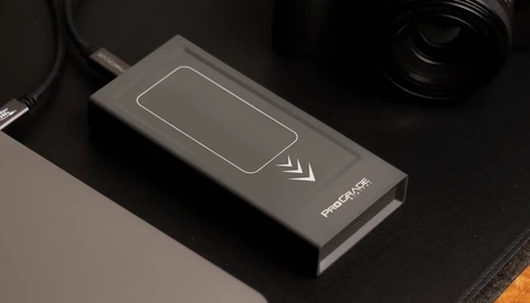 Wireless charging pad with smartphone icon and directional arrows on dark surface.
