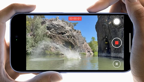 Screenshot of smartphone video recording interface showing a river landscape with rocky cliffs.