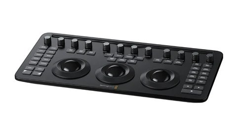Black DJ controller with three large jog wheels and multiple faders arranged across the top surface.